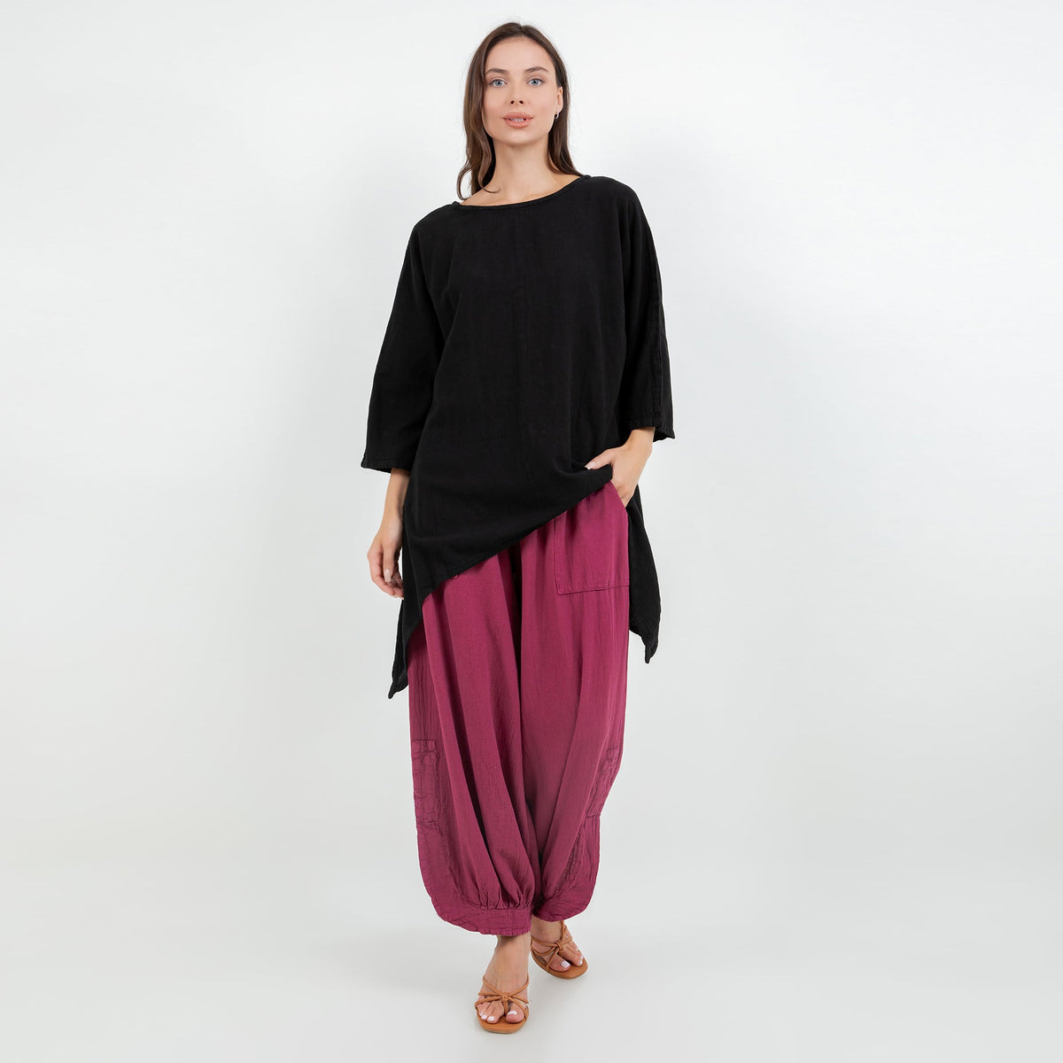 Women's cotton gauze top in black with relaxed fit and asymmetrical draped hem