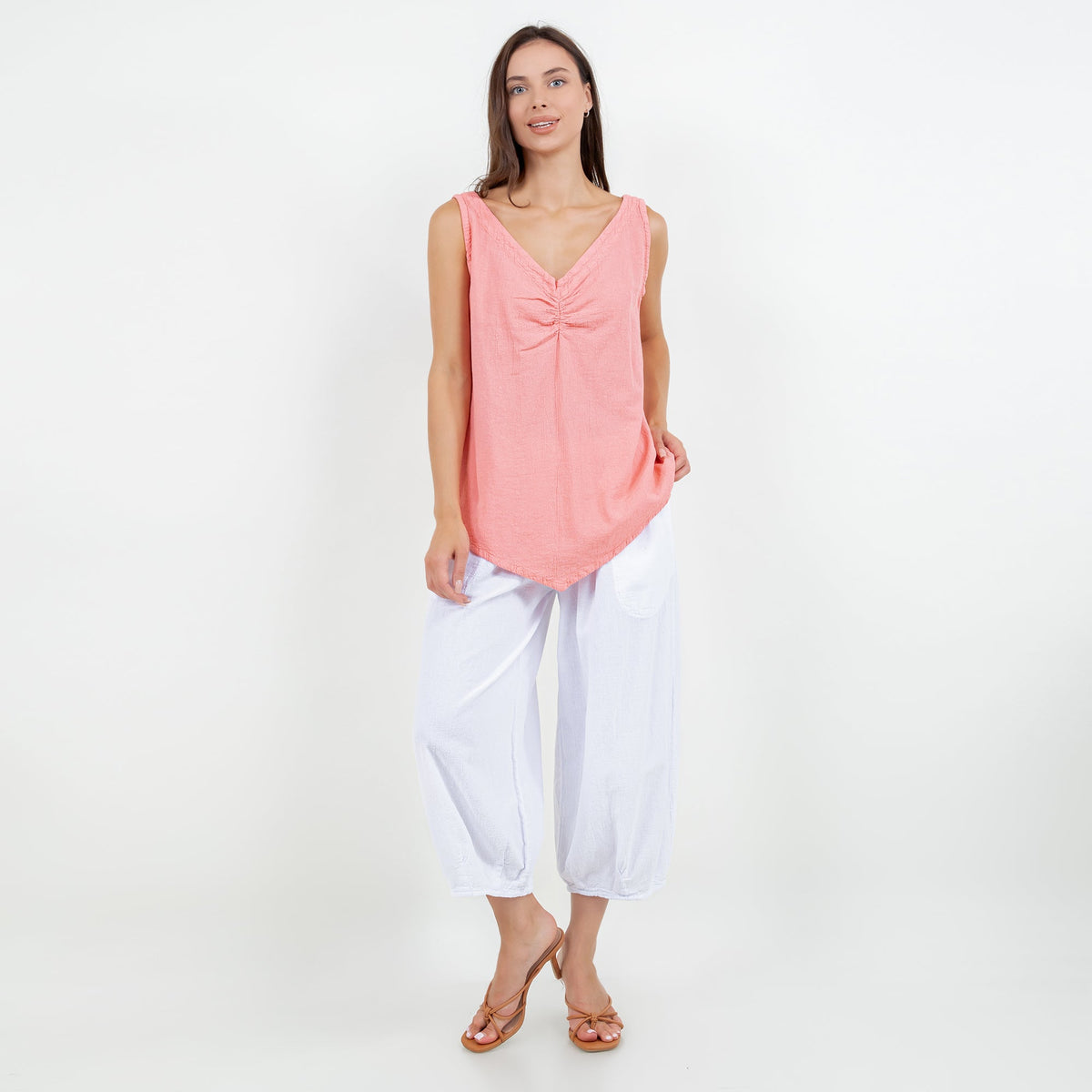 White cropped gauze pants with elastic waistband and relaxed draped fit