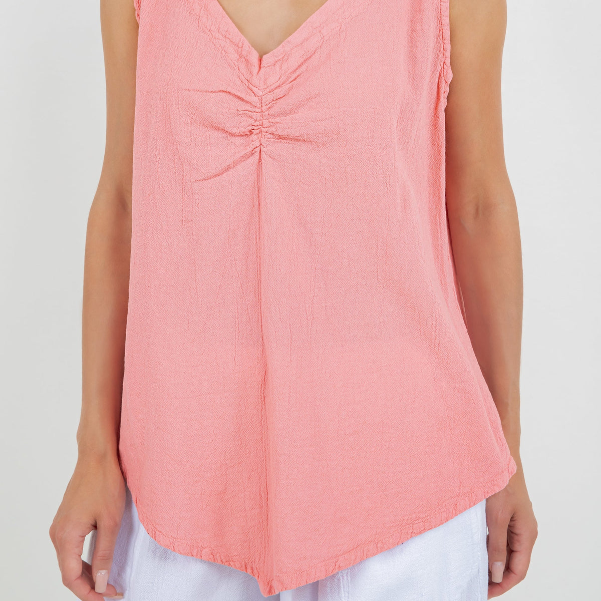 Women’s coral pink cotton gauze tank top, close-up of V-neck ruched center