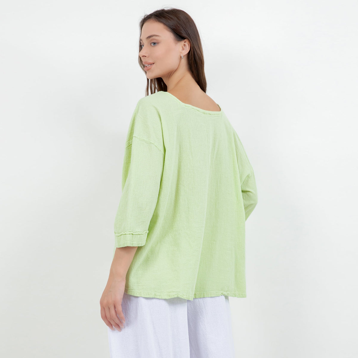 Lime green cotton gauze peasant top, side view with 3/4 sleeves and gathered hem
