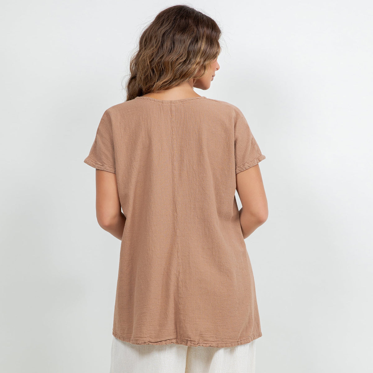 Back view of brown cotton gauze top with short sleeves and relaxed hip-length cut