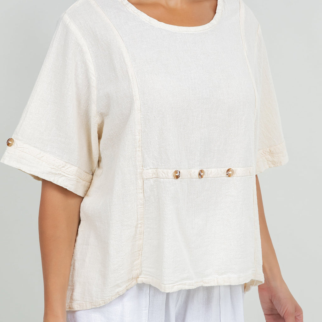 White cotton gauze Kira top close-up, button-trim front panel with draped hem