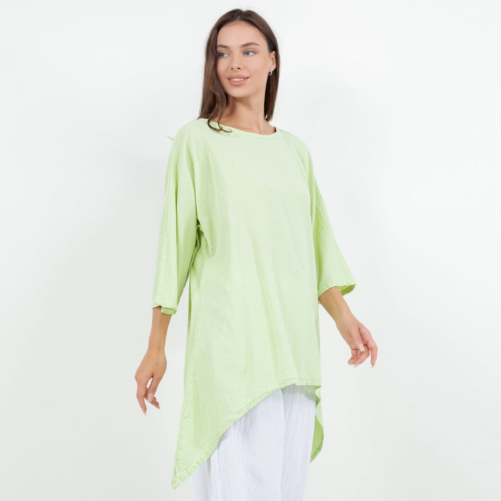 Women's cotton gauze top, lime green, side view with curved asymmetrical hem