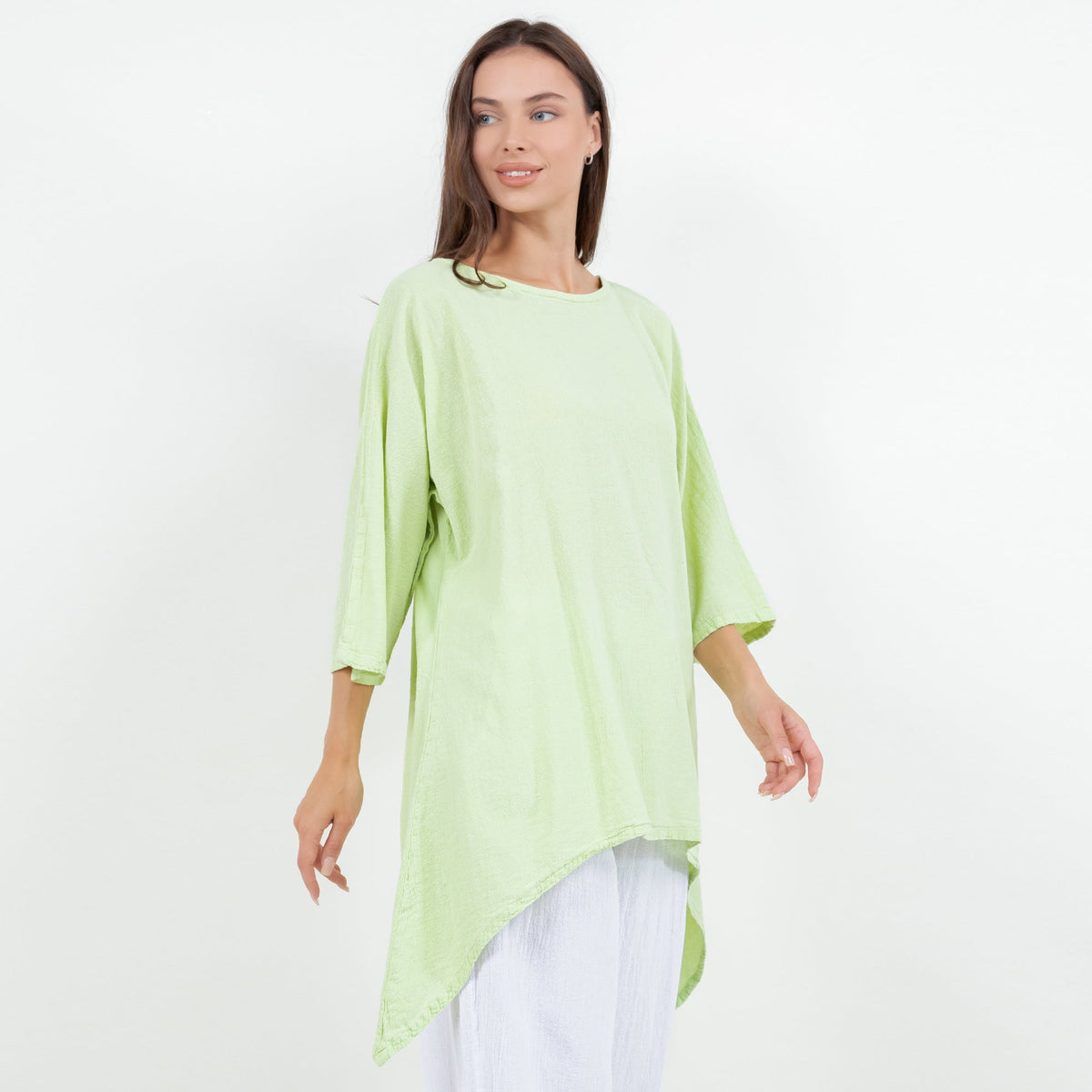 Women's cotton gauze top, lime green, side view with curved asymmetrical hem