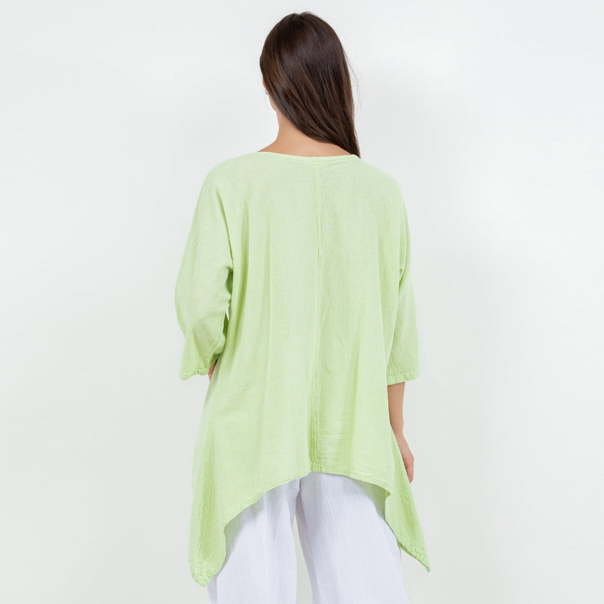 Women's cotton gauze Angela top in light green, back view with draped side hem
