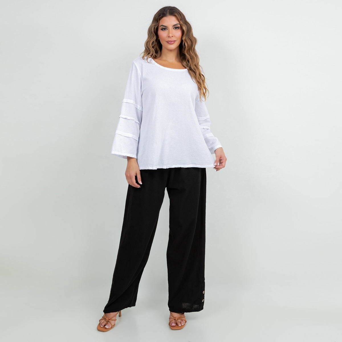 White cotton gauze sabrina top with three-quarter banded elastic sleeves and black pants