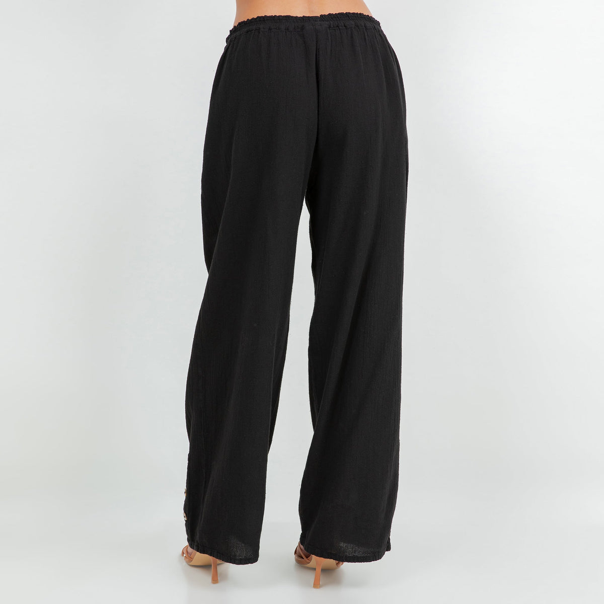 Black cotton gauze pants with elastic waistband and drapey wide-leg silhouette