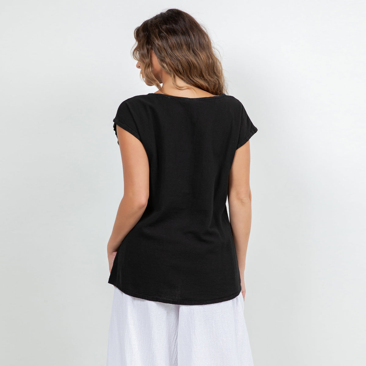 Black cotton gauze Camie top back view with short sleeves and curved hem