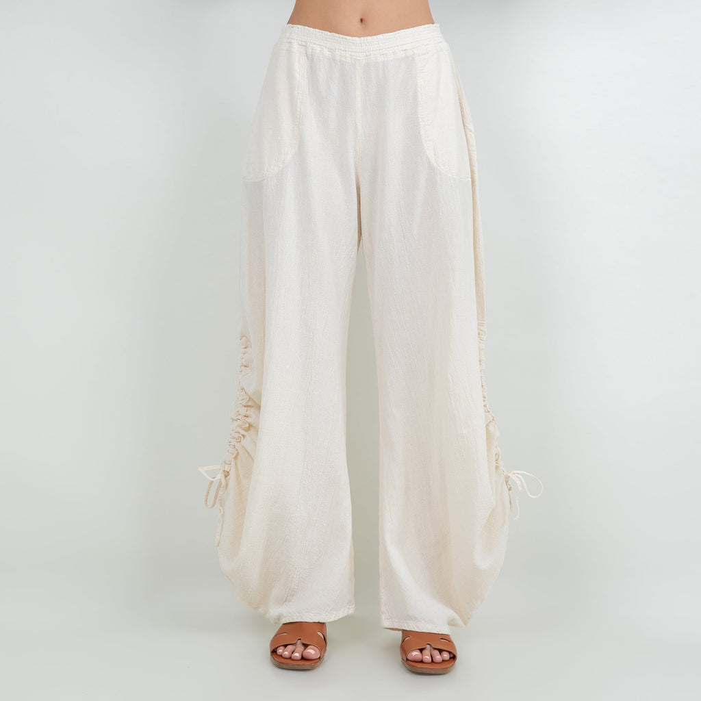 Ivory cotton gauze wide-leg pants with elastic waistband and drawstring tassel hems