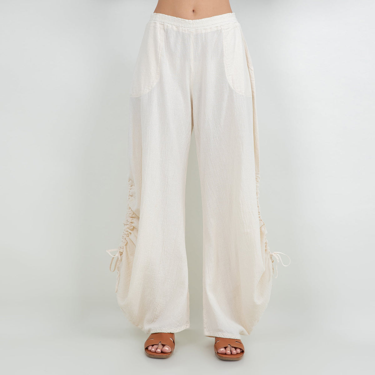 Ivory cotton gauze wide-leg pants with elastic waistband and drawstring tassel hems