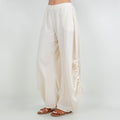 Ivory cotton gauze wide-leg pants with elastic waistband and tassel-tied cuffs