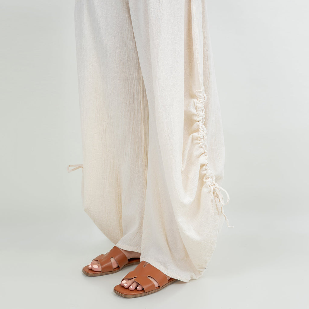 Ivory cotton gauze pants detail: ruched side cuff ties and flowy wide legs