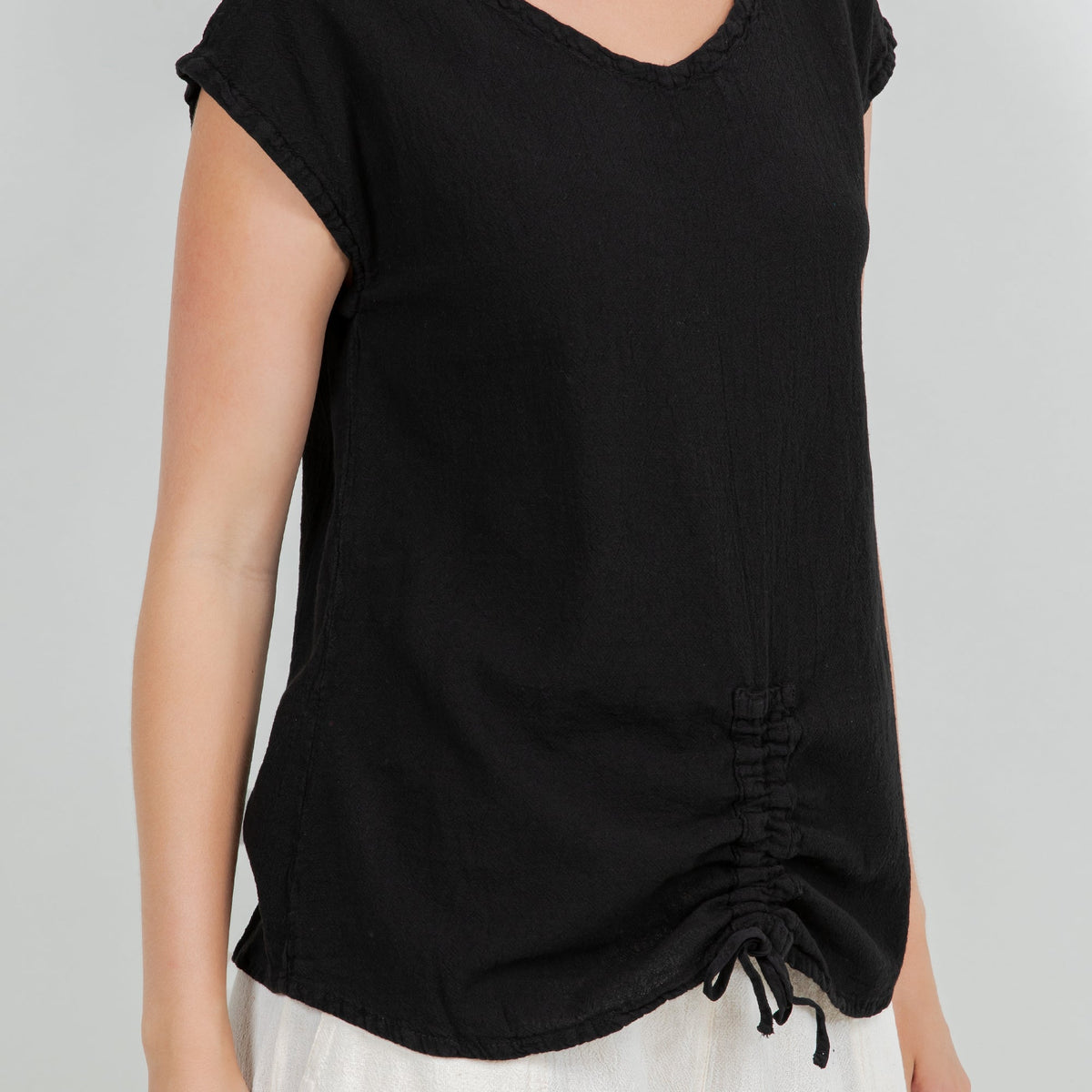 Black cotton gauze Camie top close-up of ruched hem and drawstring ties