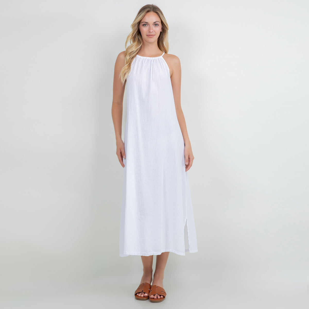 White cotton gauze halter midi dress with gathered neckline and sleeveless drape.