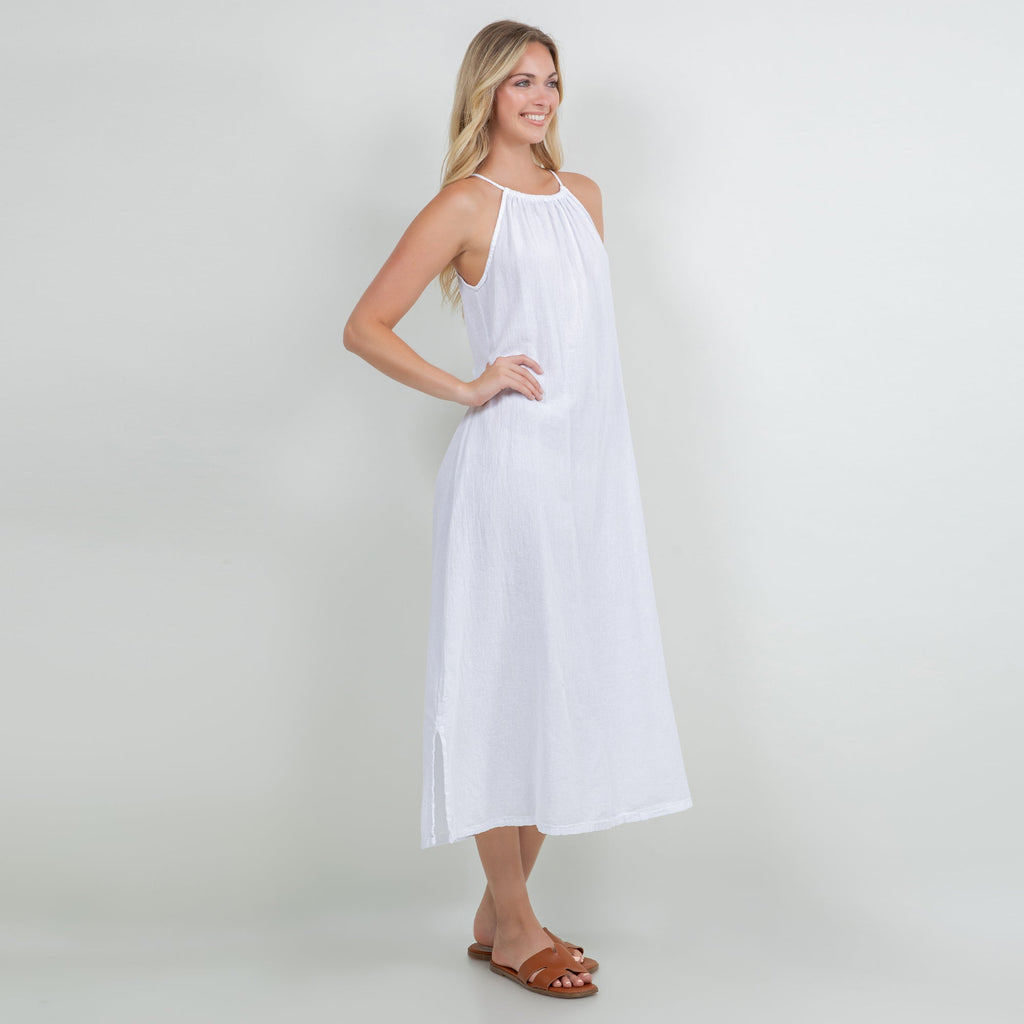 White cotton gauze halter midi dress, sleeveless with gathered neckline and flowy skirt.