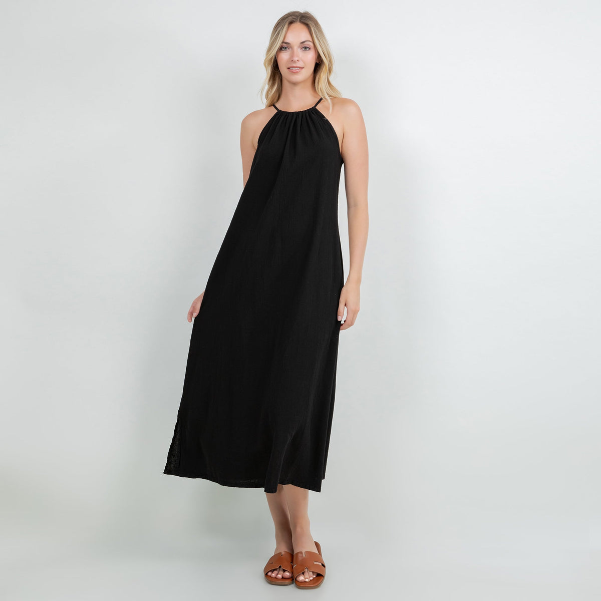 Black cotton gauze halter midi dress, sleeveless with gathered neckline and midi length.