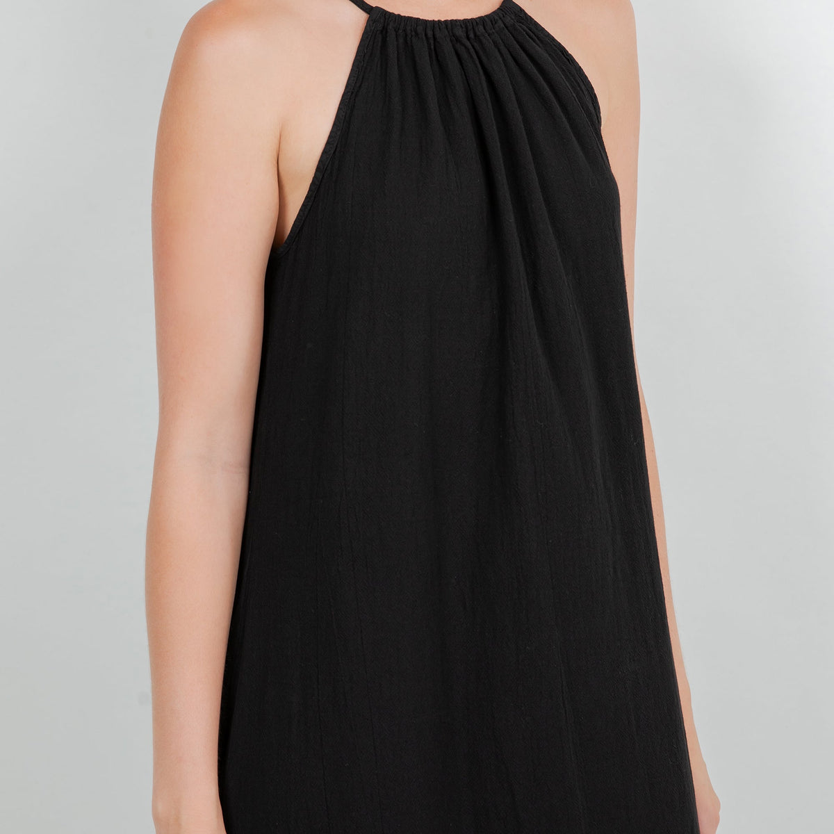 Black cotton gauze halter neckline with gathered detail and sleeveless bodice.
