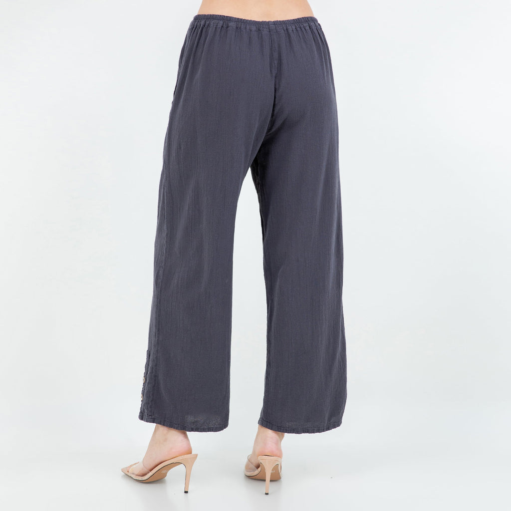 Slate blue cotton gauze pants with elastic waistband, wide legs, and cuff button detail