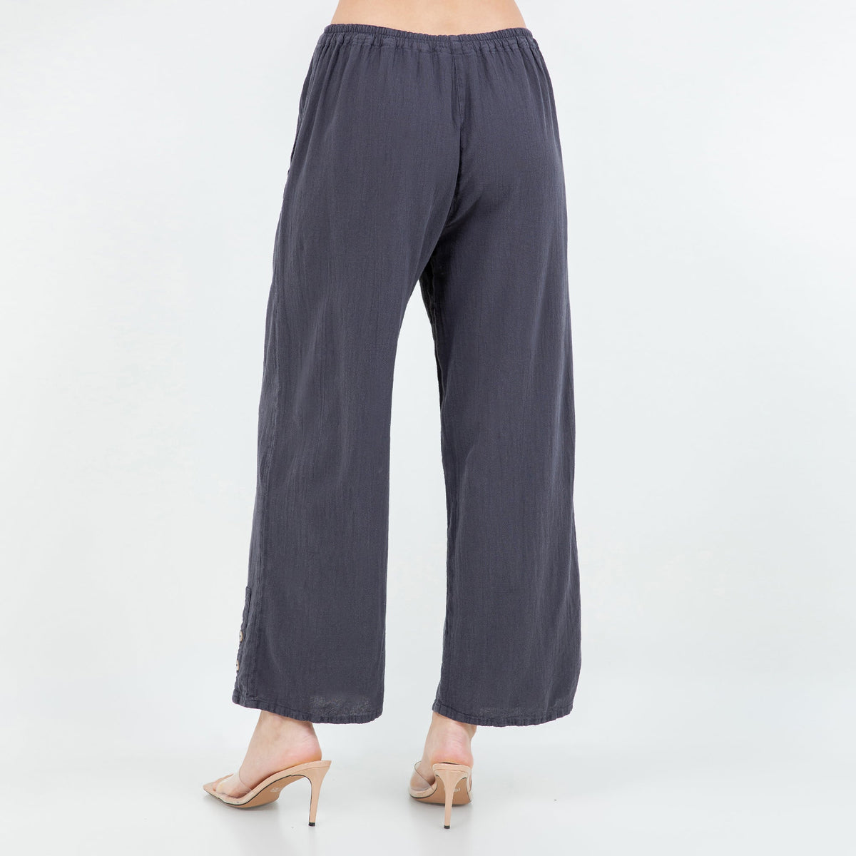 Slate blue cotton gauze pants with elastic waistband, wide legs, and cuff button detail