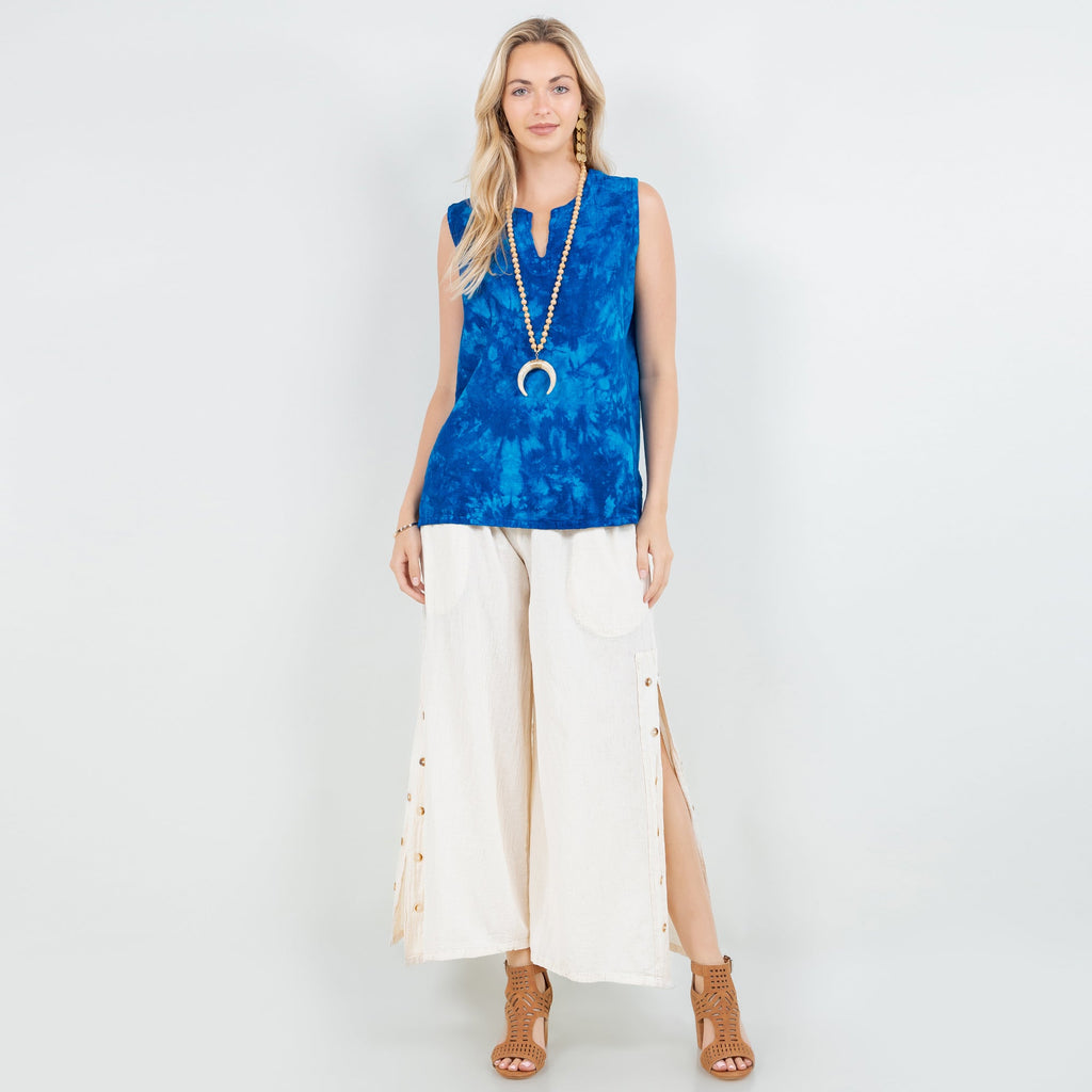 Blue sleeveless cotton gauze top with V-neck, worn with light-colored pants