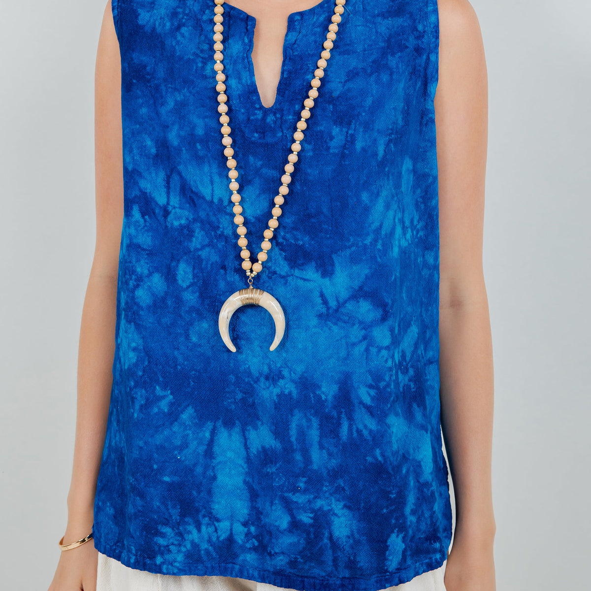 Blue sleeveless cotton gauze top with deep V-neckline