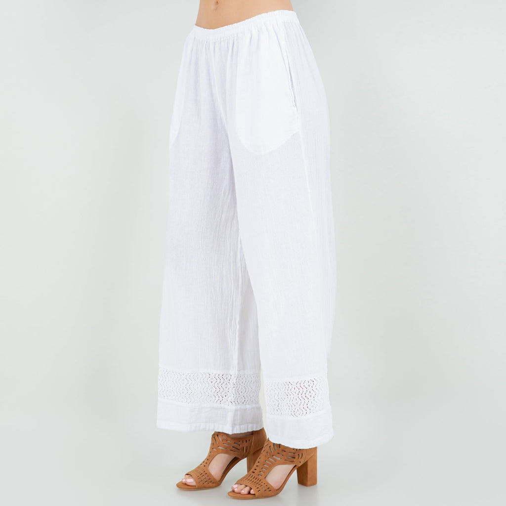 White cotton gauze wide-leg pants with elastic waist and lace trim at cuffs