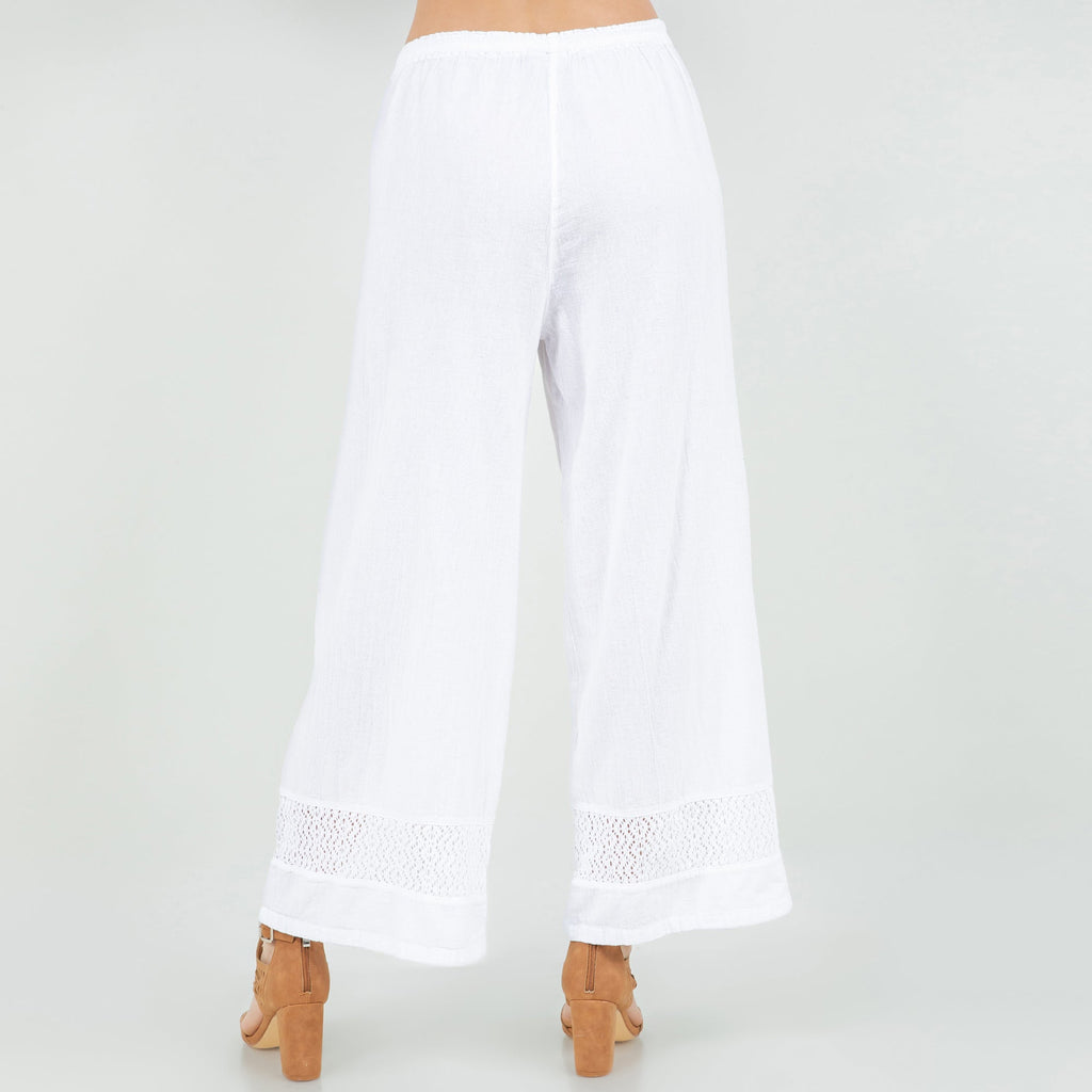 White cotton gauze wide-leg pants with elastic waistband and lace-trimmed hems