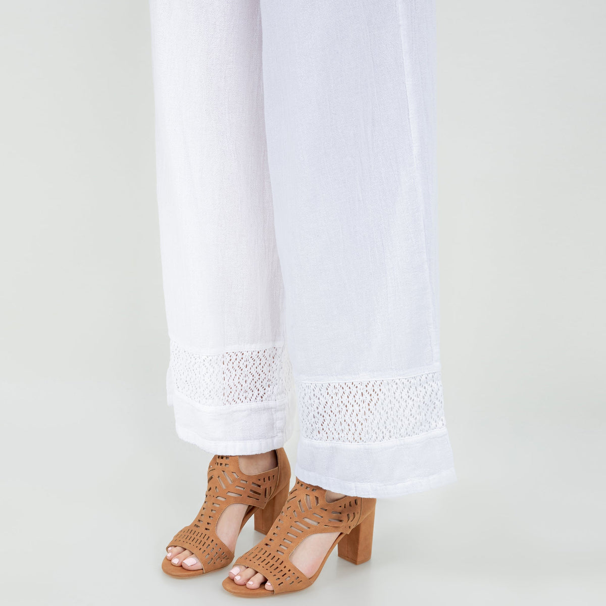 White cotton gauze pants with lace-panel hem and wide, relaxed leg opening