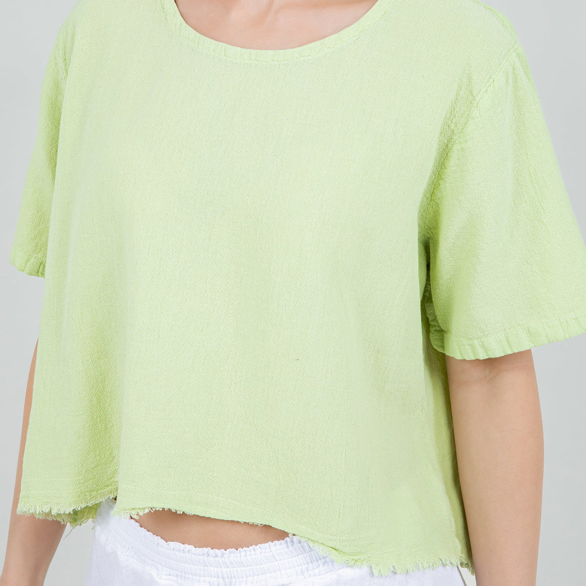 Women's gauze Heidi top close-up, lime green crew neck and flutter short sleeves