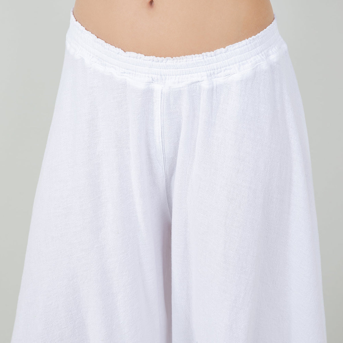White 100% cotton gauze pants with elastic waist and loose wide legs