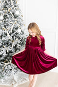 Cranberry velvet twirl dress with three-quarter sleeves and gathered skirt