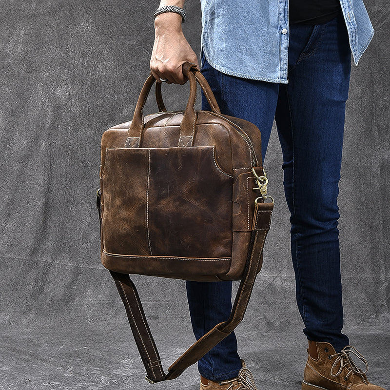 Vintage brown leather messenger bag with front zipper pocket and adjustable shoulder strap