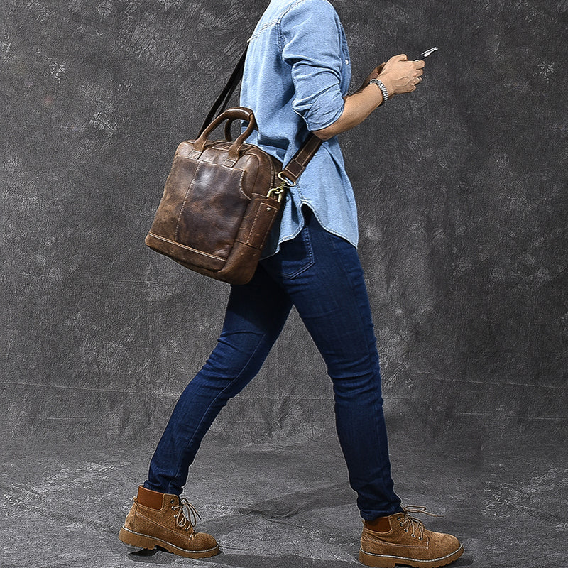 Vintage brown leather tote-style briefcase bag carried on shoulder with strap