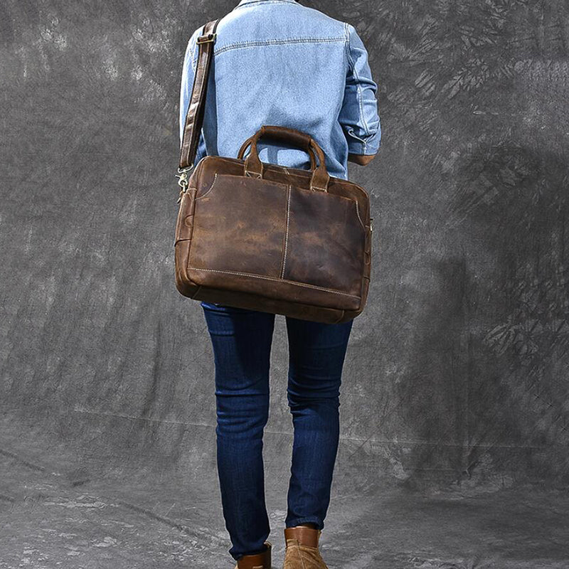 Vintage brown leather briefcase bag from back view with adjustable shoulder strap