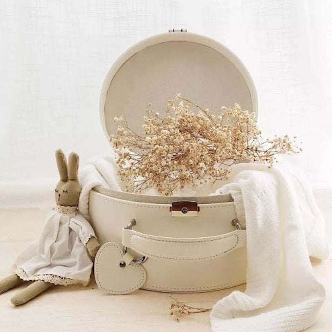 Cream round keepsake box open with beige interior, plush rabbit and dried flowers