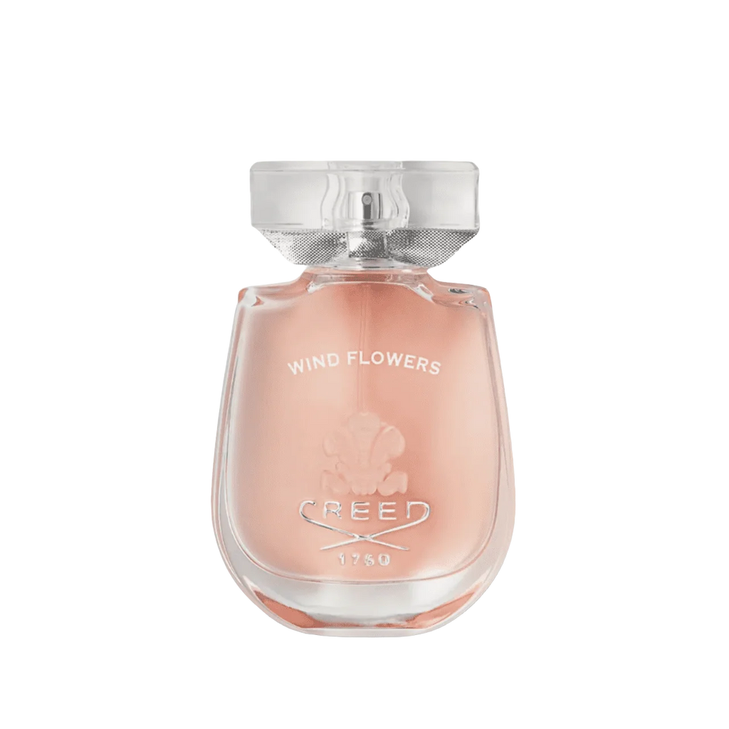 Perfume bottle with pink glass, 'WIND FLOWERS' and 'CREED' text, floral emboss