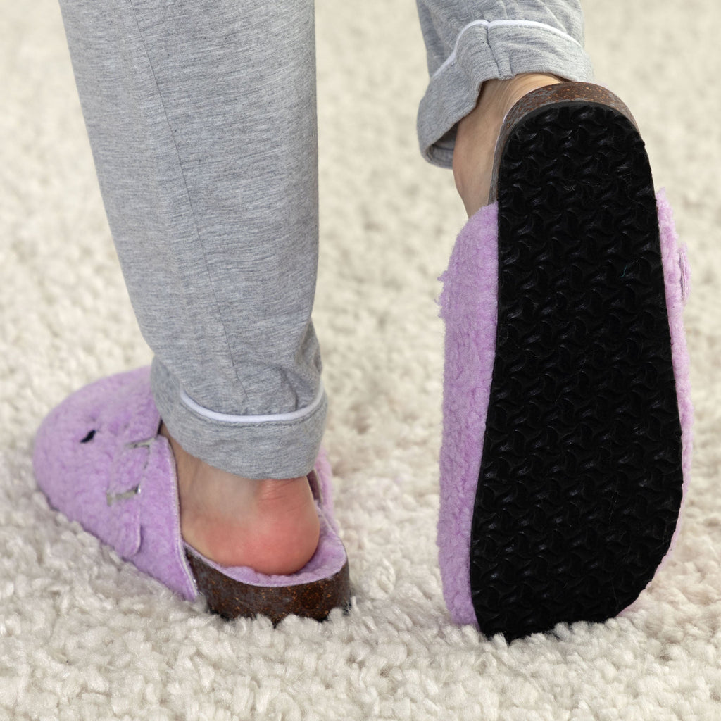 Purple plush sherpa clog slippers with brown sole trim and black tread bottom