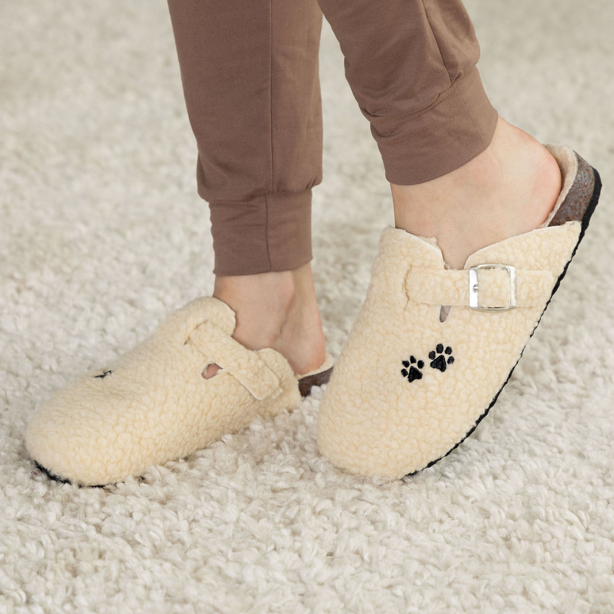 Cream sherpa clog slippers with paw-print appliques and side buckle strap