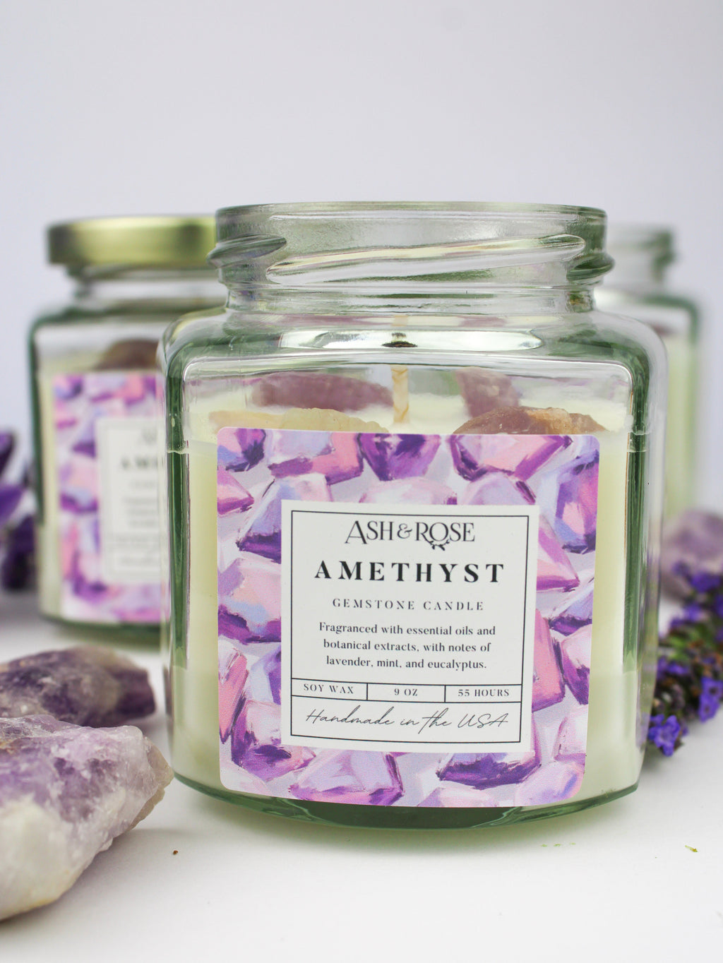 Amethyst gemstone candle jar in clear glass with layered purple crystal fragments
