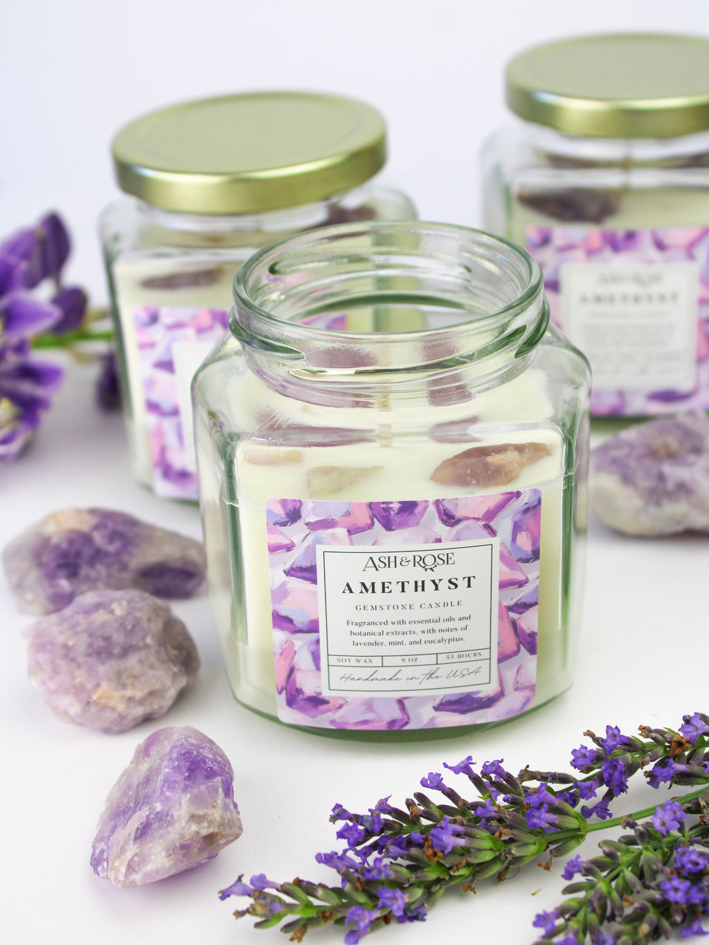 Amethyst gemstone candle in clear round glass jar with purple crystal chunks