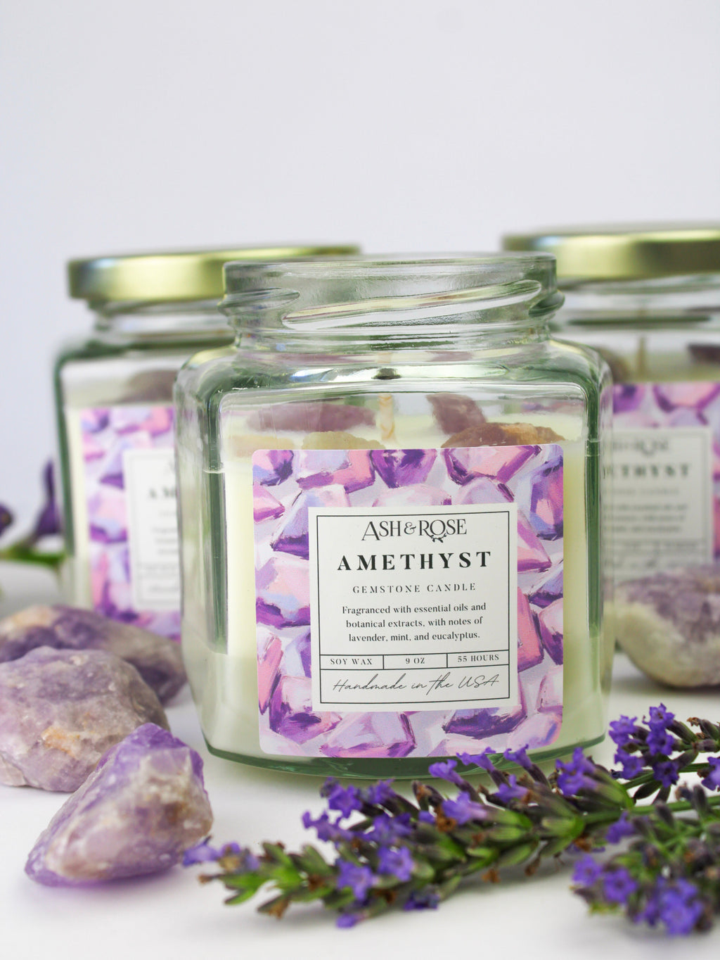 Amethyst gemstone candle in clear square glass jar with purple crystal chunks