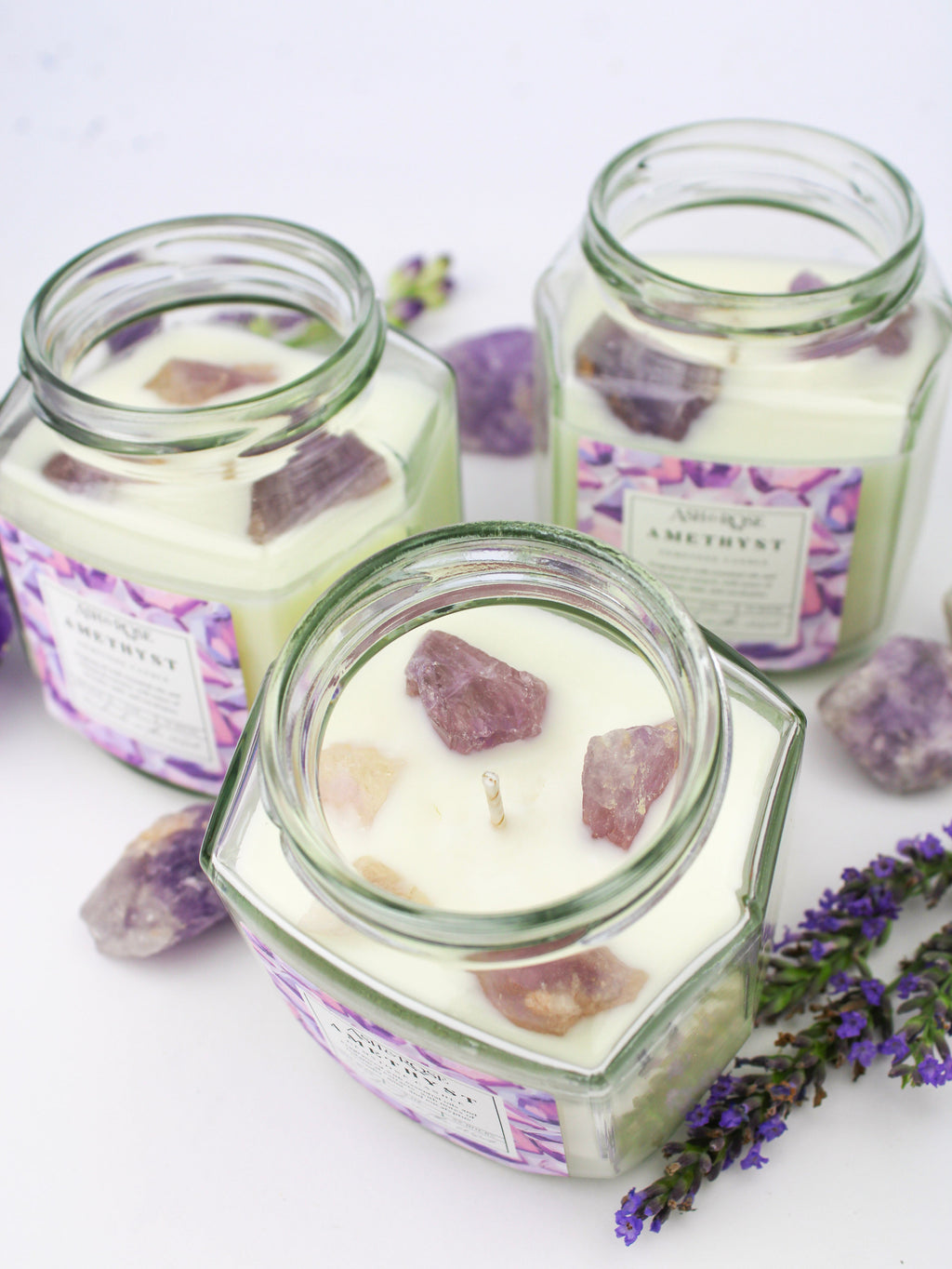 Amethyst gemstone candle in clear square glass jar with purple crystal pieces
