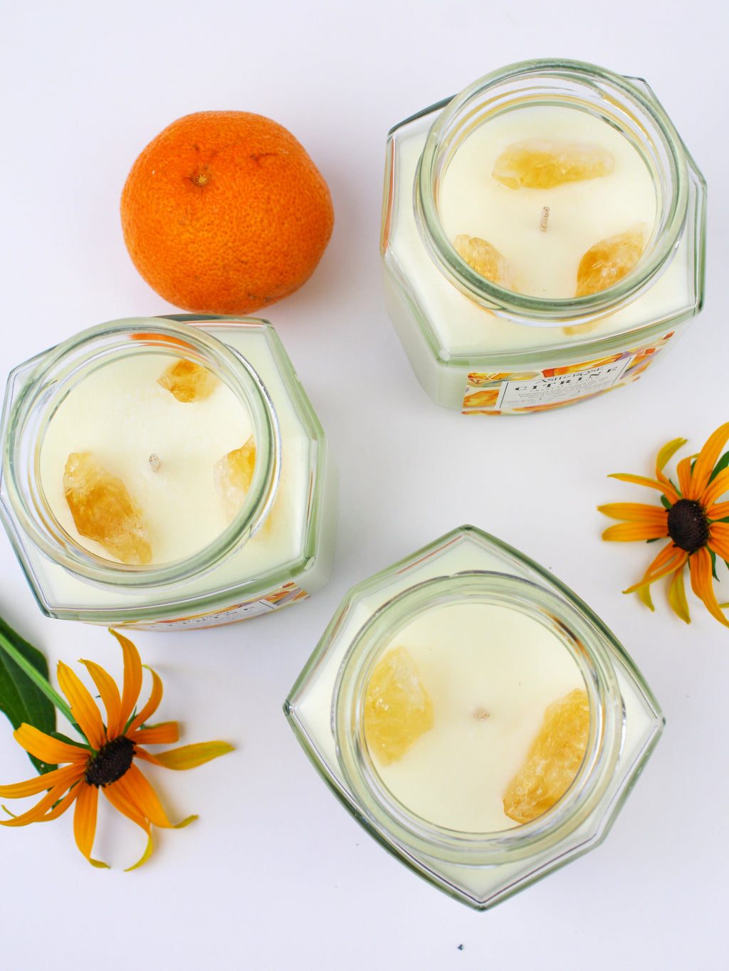 Crystal candle jars with citrine yellow wax and embedded crystal pieces