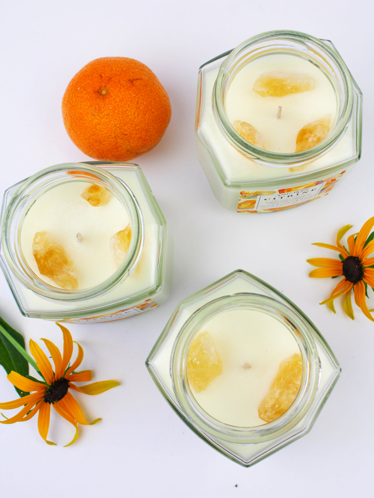Crystal candle jars with citrine yellow wax and embedded crystal pieces