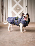 All-weather dog coat in blue geometric pattern with navy hood, side view