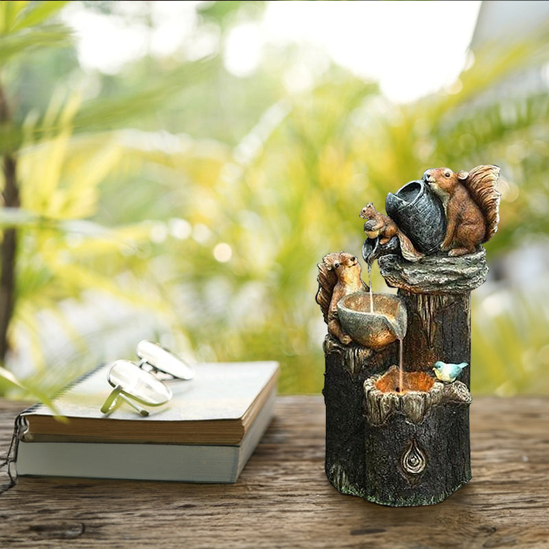 Small resin squirrel water fountain with stacked basins and glowing center