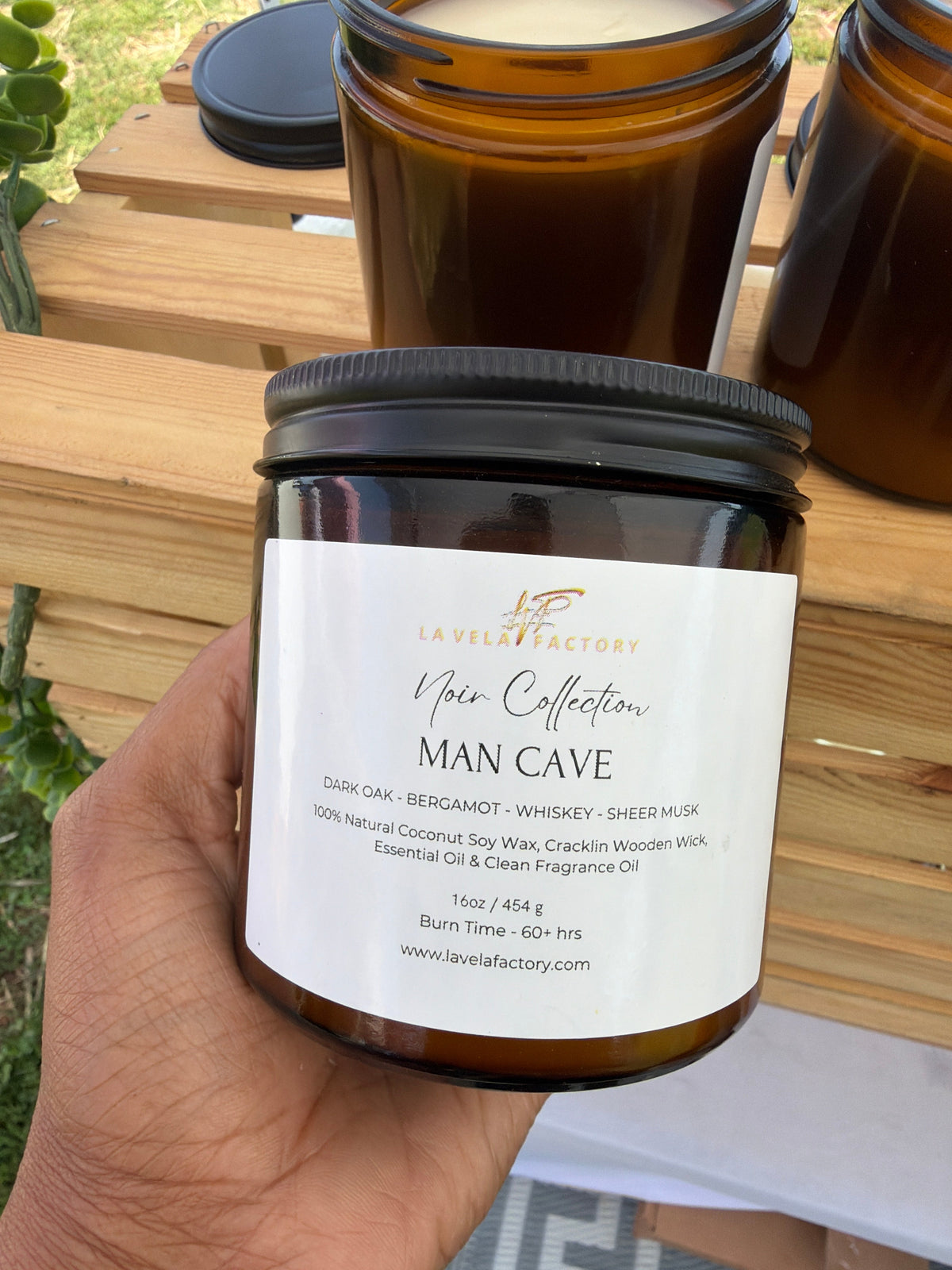Amber glass jar candle with black lid, label for “Man Cave”