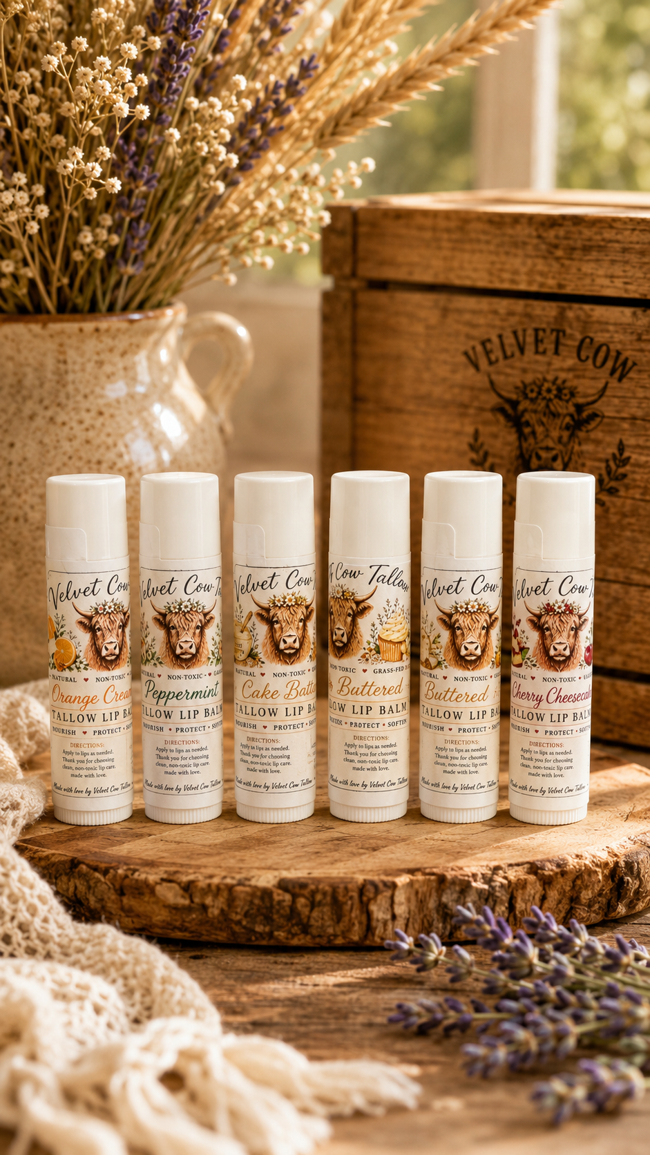 Assorted lip balm stick tubes lined up on a wooden slice