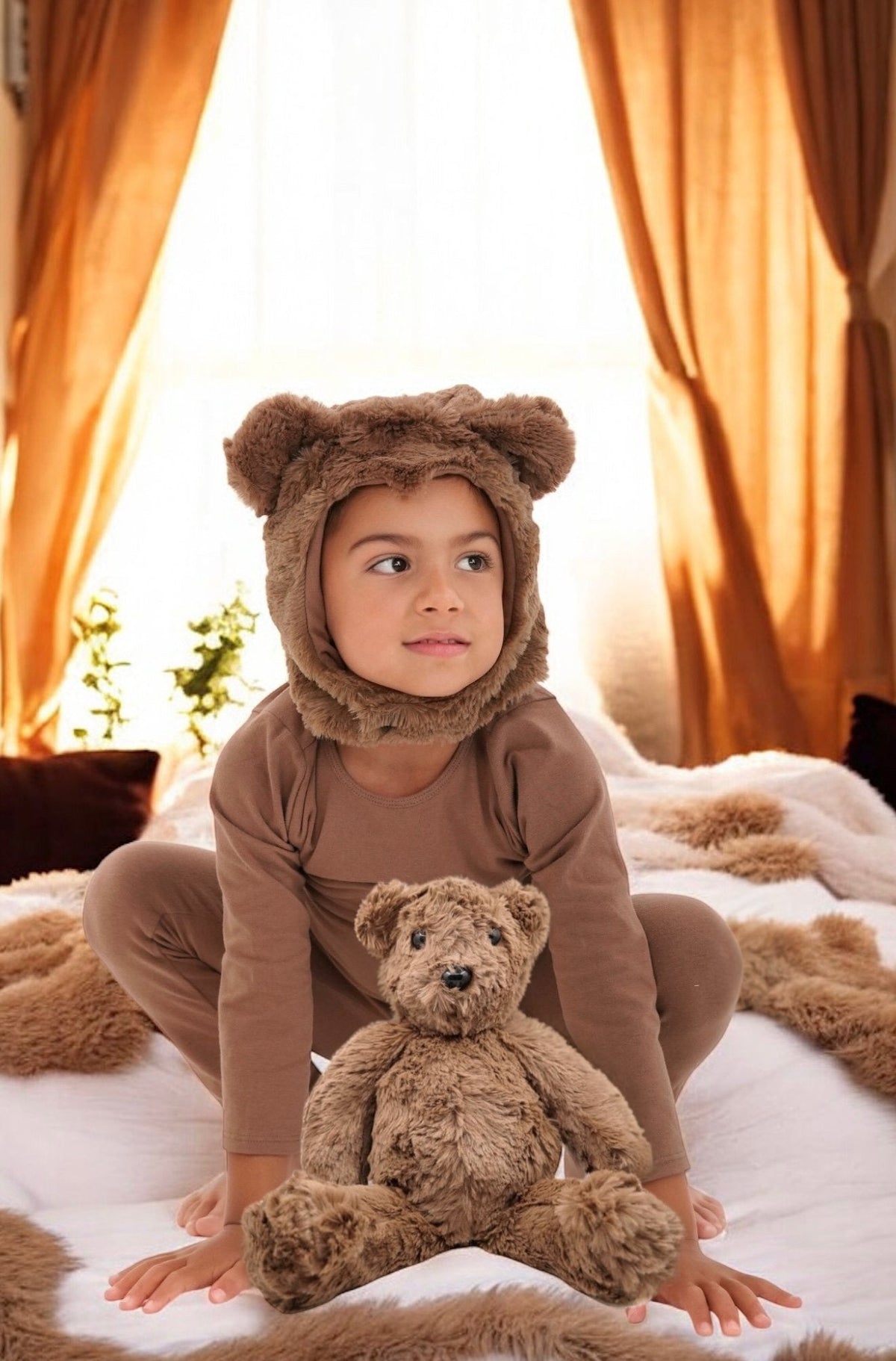 Plush teddy bear held by a child, brown fur and black bead eyes.