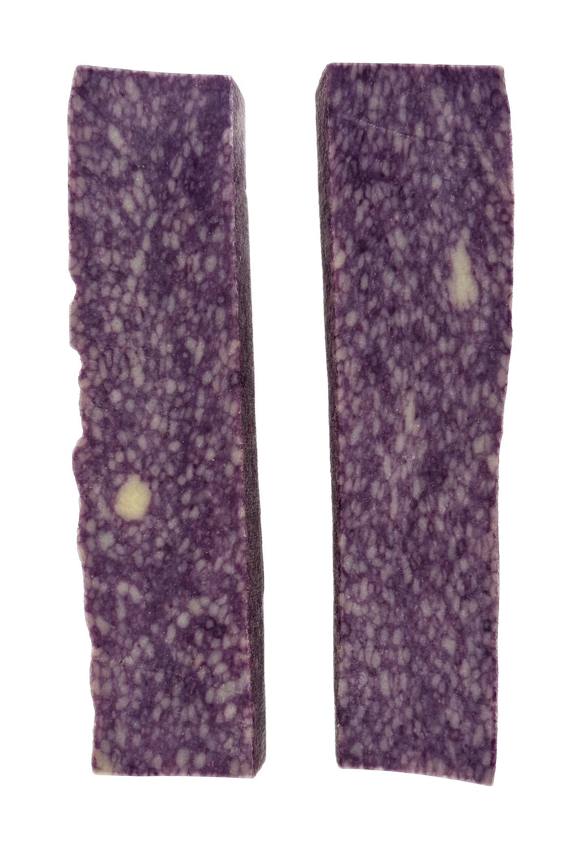 Two purple yak cheese chew sticks, speckled with lighter spots.